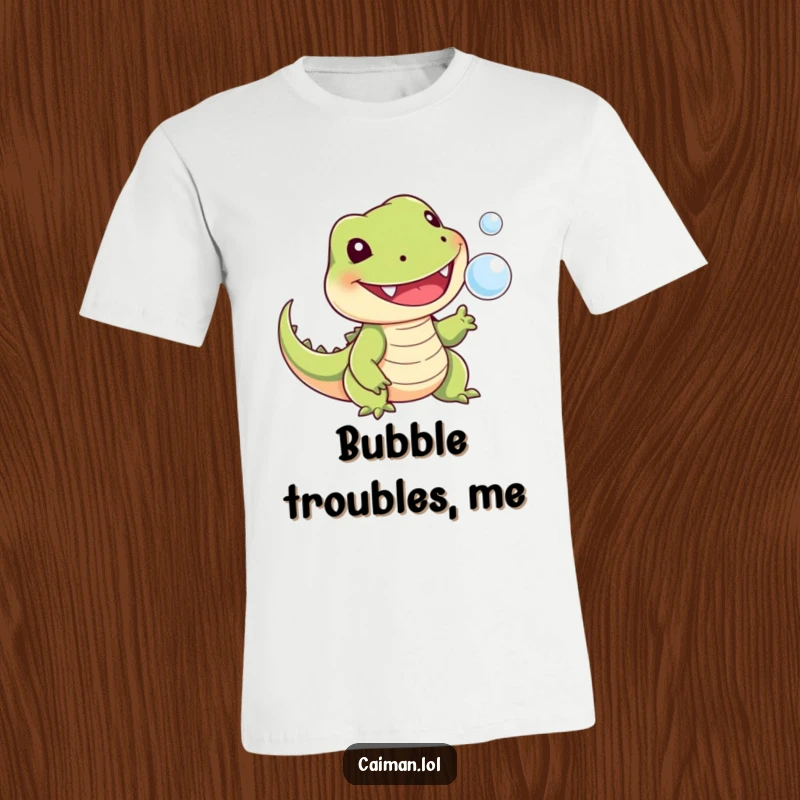 Funny t-shirt depicting a cheerful, toothy reptile with a stubby tail playfully snapping at a tiny, floating bubble, capturing a moment of lighthearted fun.